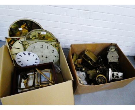 Two boxes containing miscellaneous clock parts, two painted longcase clock dials and clock fittings etc., (a large lot) 