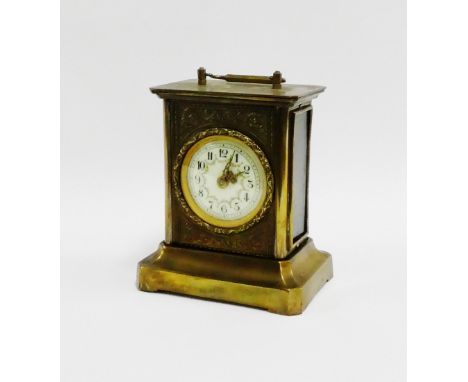 Brass cased carriage style clock with Arabic numerals, 15cm high excluding handle 