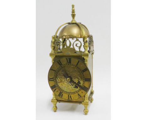 Brass lantern clock of typical form with domed top and Roman numerals to the chapter ring, 25cm high 