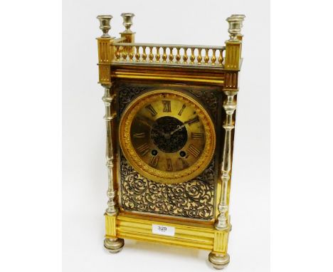French gilt brass mantle clock, with balustrade gallery above a brass chapter ring with Roman numerals with a white metal fre