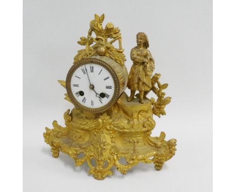 French gilt metal mantle clock, the drum head dial surmounted by a female figure and raised on an ornate base, 27cm high over