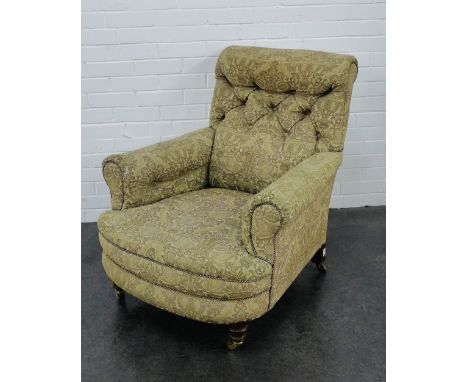 Victorian upholstered button back armchair, with turned mahogany supports with brass caps and castors, 70 x 85cm