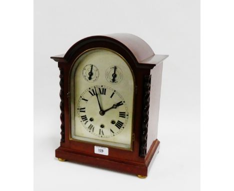 Mahogany cased German bracket style clock, the arched top over a silvered dial with Roman numerals and slow fast and chime di