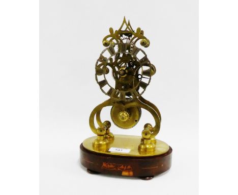 Brass skeleton clock with a silvered chapter ring and Roman numerals, with fusee movement, on a mahogany oval base with four 