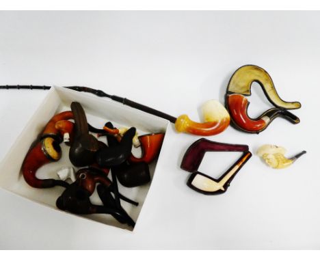 A collection of 19th and early 20th century pipes to include three with Meerschaum carved bowls, a carved hardwood bulls head