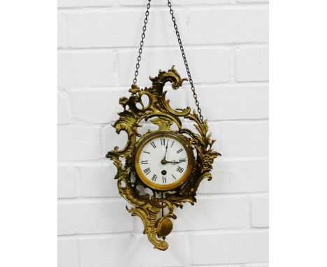 Gilt metal framed rococo style wall clock, the circular enamel dial with Roman numerals, complete with pendulum and wall hang