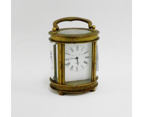Elliott & Sons of London miniature brass and glass panelled carriage clock of oval form, 8cm high excluding handle 
