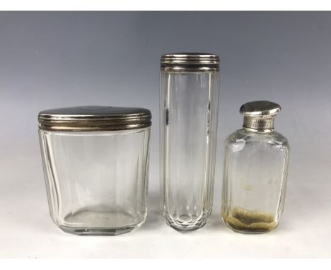 A Victorian silver mounted and cut-glass toiletry jars, having engine-turned covers and an engraved monogram