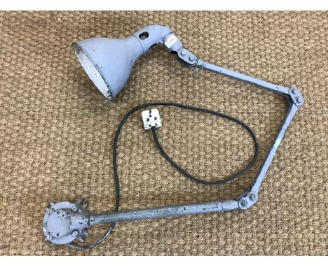 An industrial wall mounted angle poise lamp