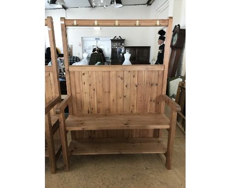 A contemporary bespoke pine settle with integral coat hooks and boot shelf, originally commissioned at a cost of £700, 127 cm