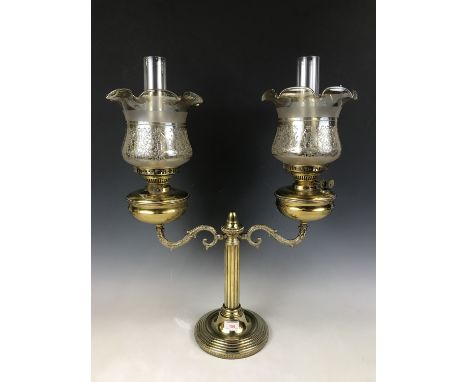 A reproduction Victorian two-branch columnar oil lamp, having duplex burners, funnels and lustrous glass shades, 69 cm total 
