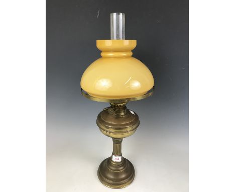 A brass oil lamp with shade, 58 cm