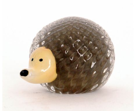 A contemporary studio glass figure of a hedgehog cased in clear crystal over tan with an applied opal glass face, unmarked. 