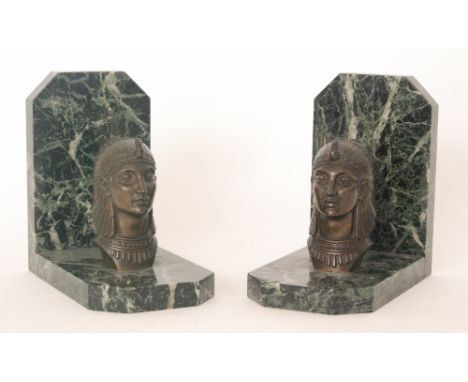 A pair of 1930s French Art Deco Egyptian revival book ends with a cast metal portrait head in head dress mounted to a variega