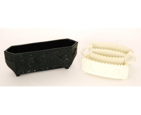 A late 19th Century Sowerby Queens Ivory pressed glass twin posy trough with two curved sections between twin handles, decora