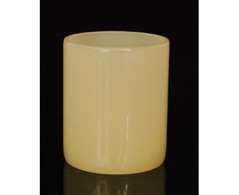 A late 19th to early 20th Century white jade beaker of cylindrical form, height 7cm