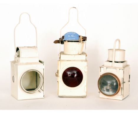 A BR cream painted railway signal lamp with with 'Person TC Work' enamelled arm badge, a similar tail lamp and a lamp case, n