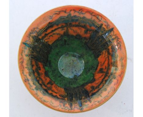 A 1920s Royal Worcester Crown Works footed bowl decorated to the interior with three stylised trees in green lustre against a