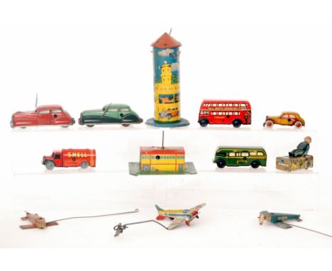 A Gesha clockwork porter with trunk wearing a blue tunic, two British tinplate aerodromes with wire operated aircraft, a Well