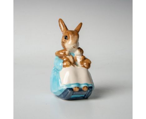 Character is modeled in blue dress, sitting on blue chair, holding two bunnies in her lap. Beswick backstamp. This item has i