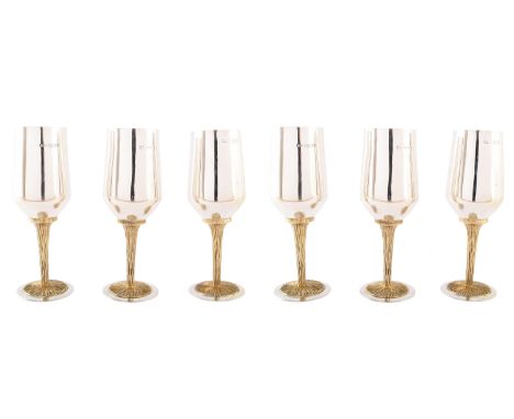 A 1970s set of six silver and metal goblets, with straight tapered gilt lined bowls, and yellow metal textured tree trunk ste