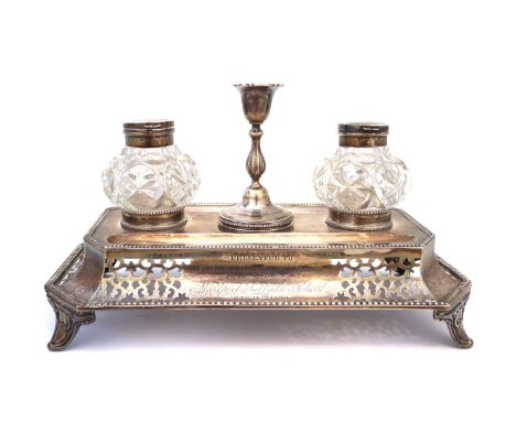 A Victorian silver ink stand, the inkstand containing two cut glass silver lidded inkwells with taper stick to centre, the oc