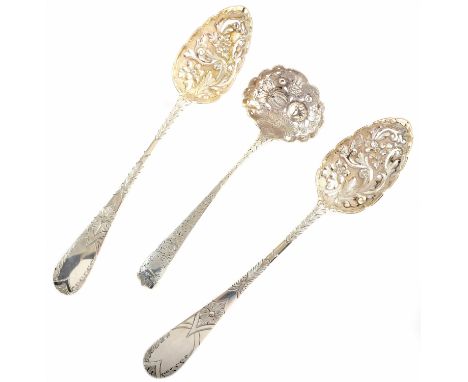 Pair of Scottish silver berry spoons, bowls with embossed floral decoration and scalloped rims and engraved decoration to han
