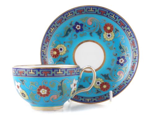 Minton Christopher Dresser design cup and saucer, decorated with raised enamel flowers on a turquoise ground inside key work 