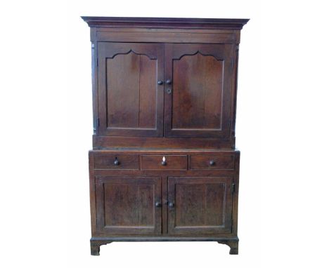 George III oak press cupboard, top section with two single panel doors flanked by quartered columns, base with three short dr