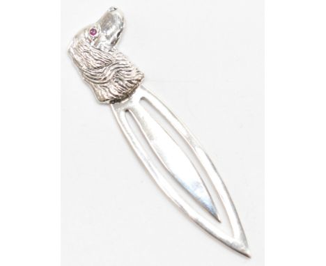 A silver dog book mark. The book mark having a dogs head finial set with&nbsp; round cut ruby eye. Measures 5.5cm. Weight 3.5