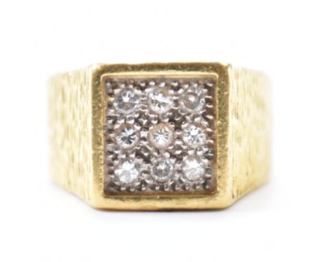 A hallmarked 18ct gold and diamond cluster ring. The ring having a square head with pave illusion set with round brilliant cu