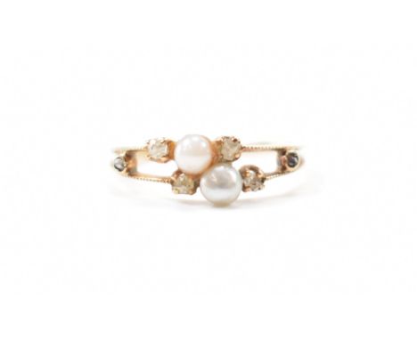 A vintage gold, diamond and pearl ring. The ring being set with six rose cut diamonds and two pearls on split shoulders. Unma