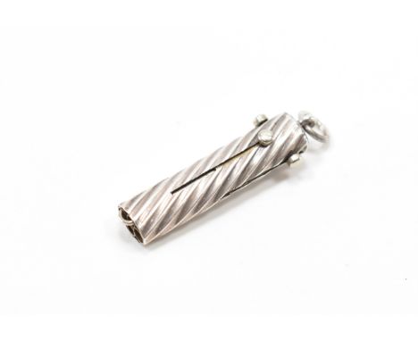 An early 20th Century silver multi tool pendant. The tool having a reeded body with four sliding tools to include a pencil, b
