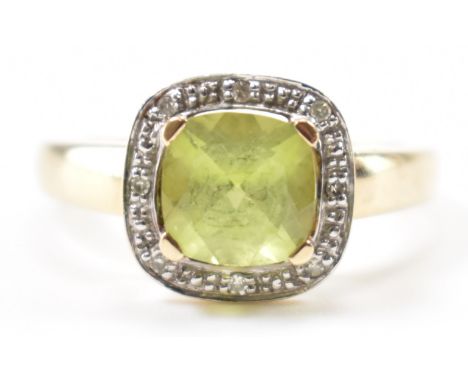 A gold peridot &amp; diamond halo ring. Stamped 375 tests indicate 9ct gold. Weighs approx 2.6g. Size O.