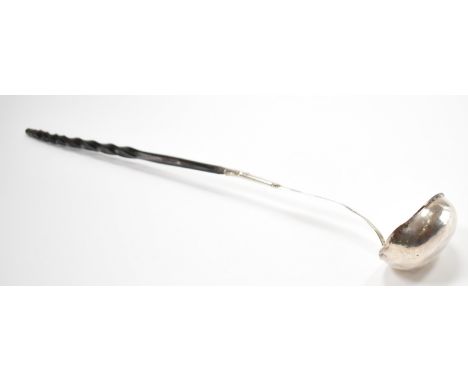 A 19th Century George III silver and whale bone ladle. The label having a hammered bowl with a twisted whale bone handle. Not
