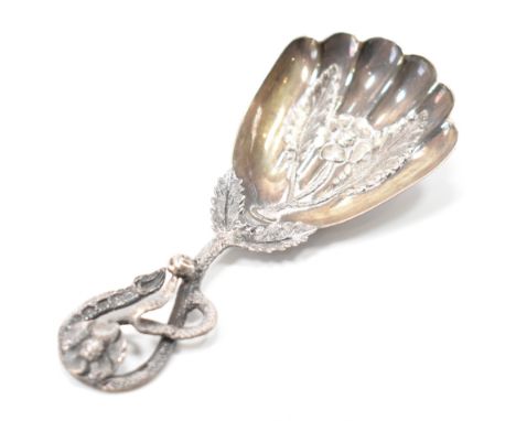 A Victorian silver hallmarked caddy spoon with shaped scallop bowl having foliate handle. Believed to be hallmarked Birmingha