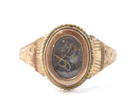 A 19th Century Victorian hallmarked 9ct gold signet ring. The ring having an oval head with a glass panel revealing hair work