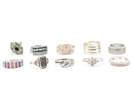 A collection of silver &amp; white metal rings. To include; three CZ / white stone set rings, navette marcasite ring, two dec