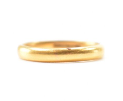 A hallmarked 22ct gold band ring. The ring of plain D form. Hallmarked Birmingham 1935. Weight 5.2g. Size S.5.