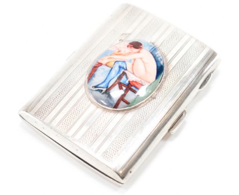 A silver hallmarked cigarette case. The case having engine turned decoration with an oval enamelled panel to the centre featu