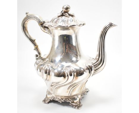 A 19th Century William IV silver hallmarked coffee pot. The pot having shaped gadrooned sides with a scrolled handle and curv