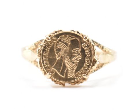 A hallmarked 9ct gold greek coin style ring. The ring having a round panel to the head marked MAXIMIJIANO EMPERADOR. Hallmark