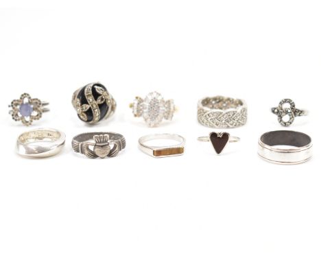 A collection of silver &amp; white metal rings. To include; one gilt white stone set ring, three marcasite rings, two band ri