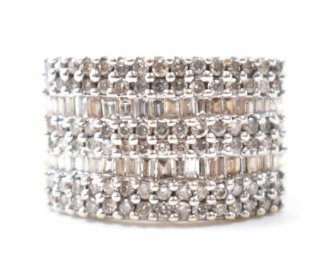 A hallmarked 9ct gold &amp; diamond cluster ring. The ring set with round brilliant &amp; baguette cut diamonds. Hallmarked f