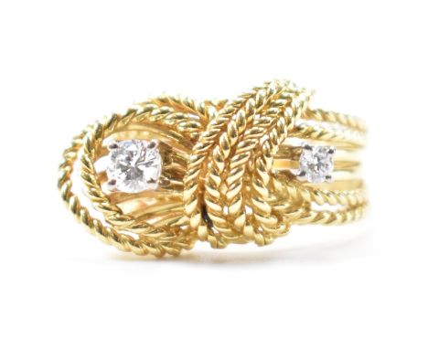 A vintage gold and diamond knot ring. The rope design ring being set with two round brilliant cut diamonds. Unmarked, tests i
