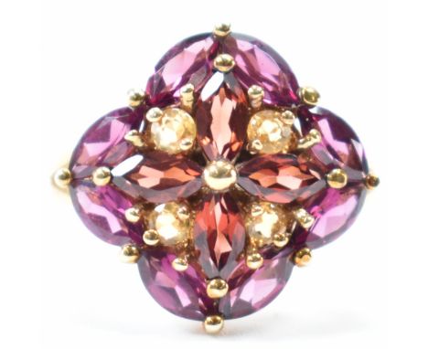 A hallmarked 9ct gold cluster ring. The ring having navette &amp; round cut red, yellow &amp; purple stones in a floral desig