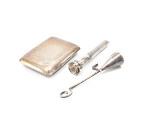 A hallmarked silver vesta case with other smoking paraphernalia.&nbsp;The case having engine turned detailing and an engraved