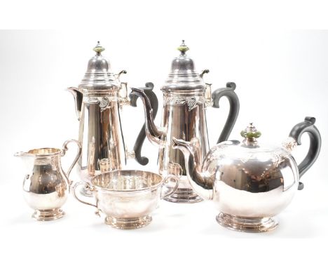 A vintage 1960s Irish silver hallmarked tea service. The service having engraved shell and foliate detailing with green stone