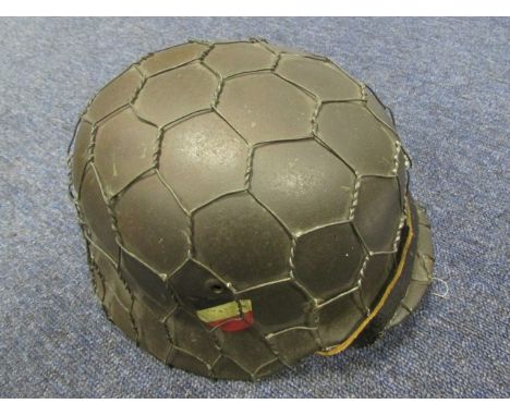 German WW2 Model 1935 steel helmet. Original field grey finish with both Wehrmacht decals. Fitted with original chicken wire 