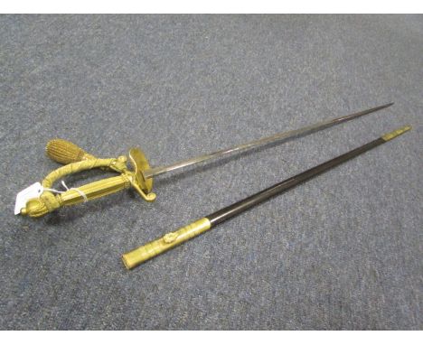 Sword: An English Court sword made by 'Wilkinson Sword'. Elizabeth II logo to blade. In its brass mounted leather scabbard. G